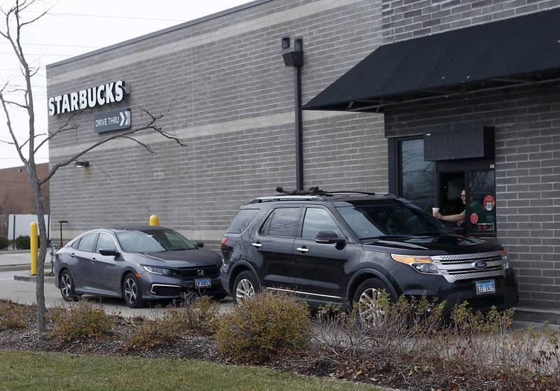 Customers pick up orders Thursday, Nov. 17, 2022 at the Cary Starbucks location on Starbucks' Red Cup Day. Workers at Starbucks in Cary joined other workers across the country seeking to convince the company to better negotiate with its unionized locations.
