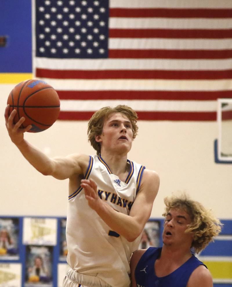 Johnsburg's Dylan Schmidt drives to the basket against Woodstock’s Jackson Lyons during a Kishwaukee River Conference boys basketball game Tuesday, Jan. 31, 2023, at Johnsburg High School.