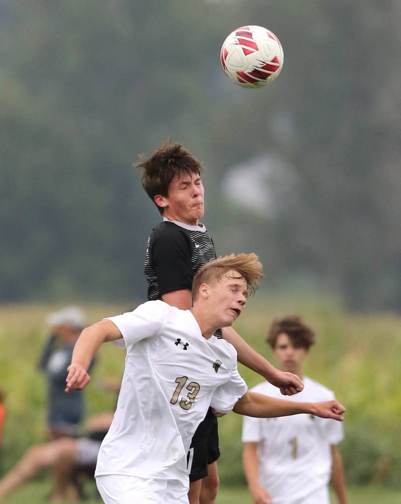 Kaneland's Cameron Guernon heads the ball over Sycamore's Aiden Sears during their game Wednesday, Sept. 6, 2023, at Kaneland High School in Maple Park.
