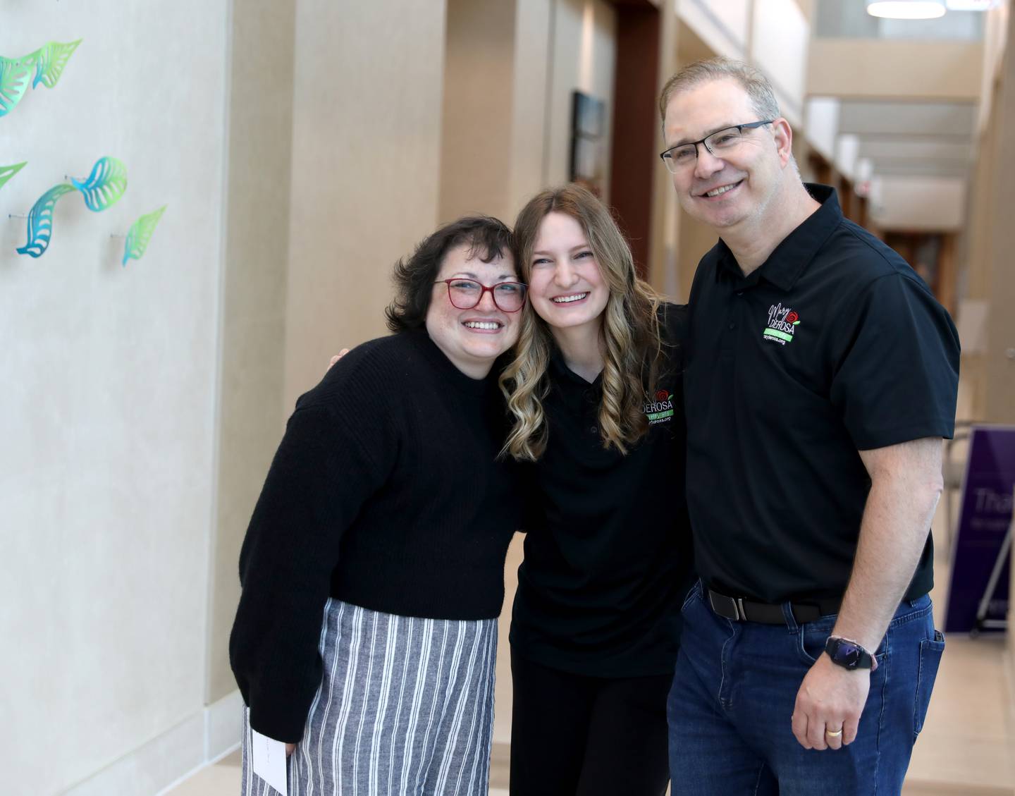 Christina Keasler of St. Charles (left) poses for a photo with Bella DeRosa, 17, and Guy DeRosa of South Elgin on Thursday, May 1, 2025 at the Northwestern Medicine Cancer Center Delnor in Geneva. Keasler is the first recipient of a gift from the Mary DeRosa Foundation, a charity founded by Mary’s widower, Guy DeRosa, and his children to support others with cancer. Mary DeRosa of South Elgin died of metastatic triple-negative breast cancer in 2022.