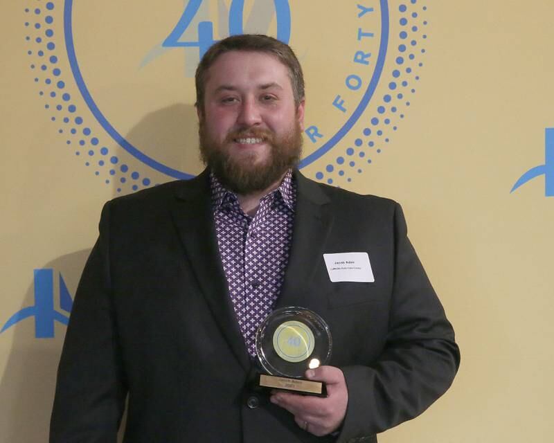 Jacob Aden poses for a photo with his award during the 40 Under Forty awards banquet on Thursday, March 21, 2024 at Westclox in Peru.