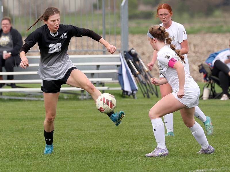 Kaneland's Erin Doucette (left) kicks the ball away from Sycamore's Cortni Kruizenga Wednesday, April 30, 2025, during their game at Kaneland High School in Maple Park.