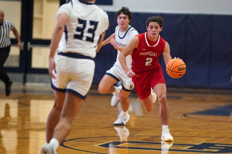Hinsdale Central's Dillon Orozco (2) dribbles the ball up the court against Oswego East during a hoops for healing tournament basketball game at Oswego East High School on Tuesday, Nov. 26, 2024.