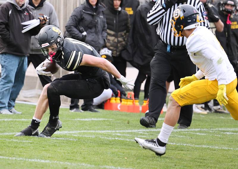 Sycamore's Burke Gautcher tries to stay in bounds as Sterling's Isaiah Mendoza  looks to bring him down during their Class 5A state playoff game Saturday, Nov. 12, 2022, at Sycamore High School.