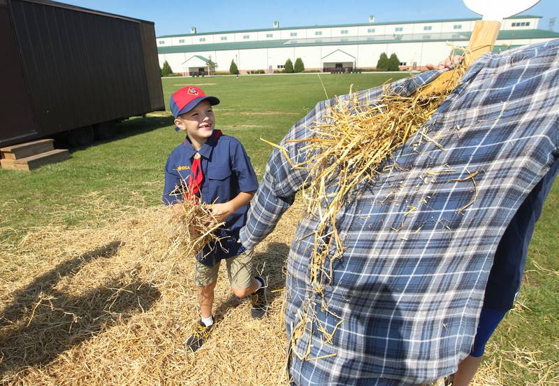 Russell Poyner, 7, of Grayslake stuffs a scarecrow with straw as Aaron Wagner, 8, of Wauconda stands behind it during the Lake County Farm Heritage & Harvest Festival at the Lake County Fairgrounds on September 23rd in Grayslake. The boys were with Cub Scout Pack 189. The festival was sponsored by the Lake County Farm Heritage Association.
Photo by Candace H. Johnson for Shaw Local News Network