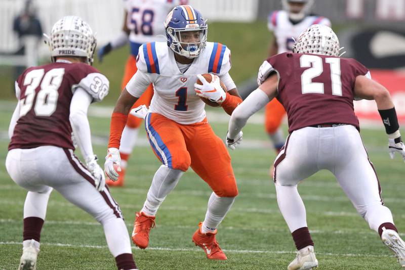 East St. Louis receiver Lawaun Powell Jr. tries to get by Prairie Ridge's Matt Fryer (left) and Matt Loucks during their Class 6A state football championship game last November in Huskie Stadium at Northern Illinois University.