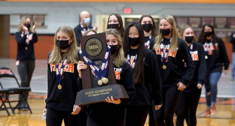 Crystal Lake Central held a celebration Sunday in their gymnasium after the Tigers on Saturday won the IHSA state title in Competitive Cheerleading-Medium Team at Grossinger Motors Arena in Bloomington. Abby Stephan carries the trophy as she leads her teammates into the gym.
