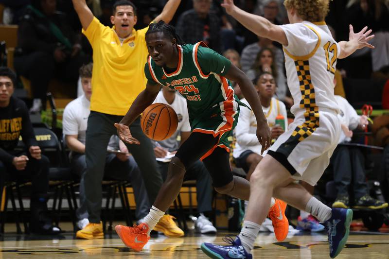 Plainfield East’s Nana Atakorah-Yanzu works the ball up court against Joliet West on Friday, Dec. 19, 2025 in Joliet.