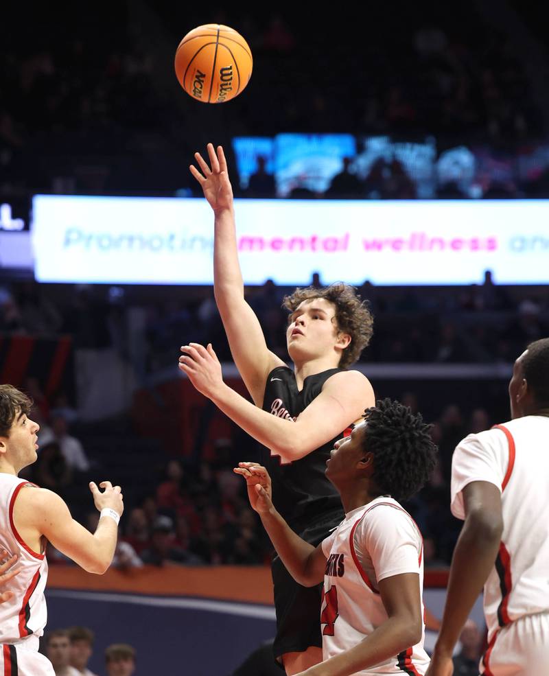 Benet's Ethan MacDermot shoots the ball over Marist's Charles Barnes Jr. Saturday, March 14, 2026, during their IHSA Class 4A state championship game in the State Farm Center at the University of Illinois in Champaign.