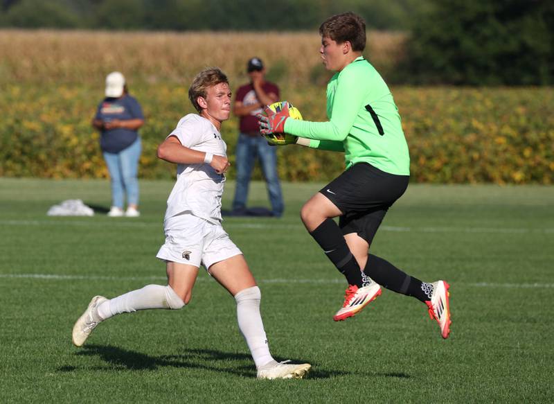 Kaneland's Aidan Lentz makes a save just ahead of the rush of Sycamore's Gavin Crouch during their game Wednesday, Sept. 16, 2025, at Kaneland High School in Maple Park.