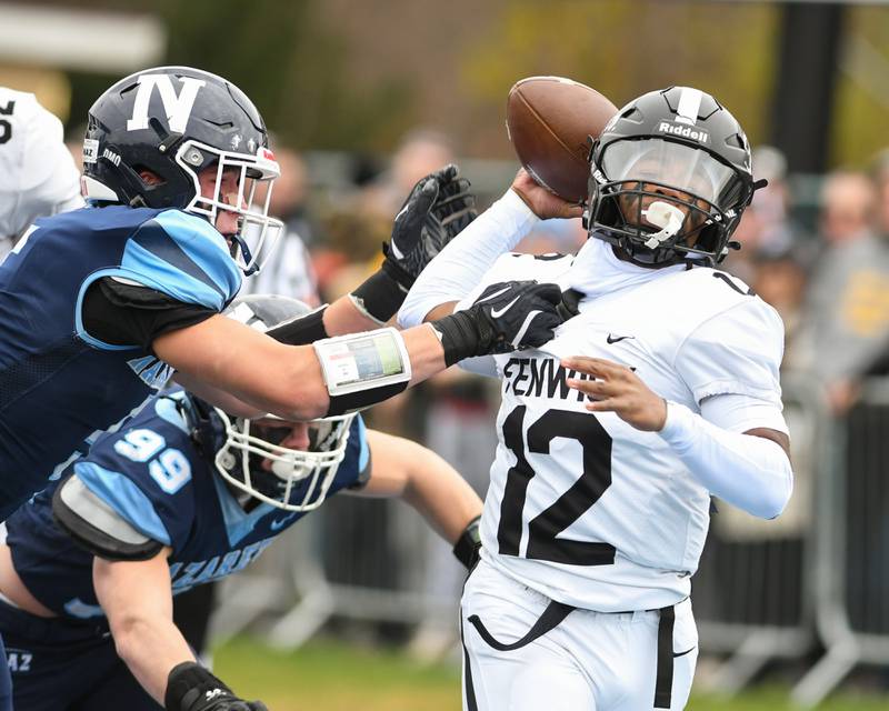 Fenwick's Jamen Williams (12) passes the ball before being tackled by Nazareth Academy's Christopher Kasky (5) and Nazareth Academy's Will McGarry (99) during the 6A semifinals game on Saturday Nov. 22, 2025, held at Nazareth Academy High School in La Grange Park.