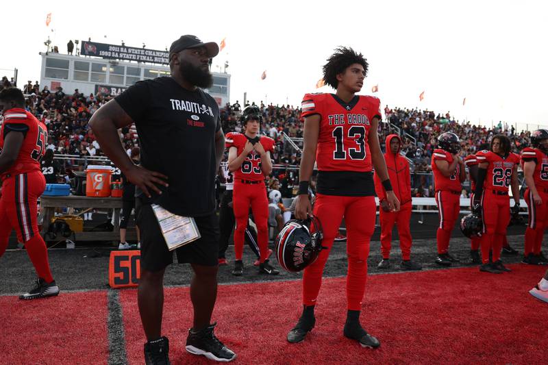 Bolingbrook’s Jonas Williams talks with a coach between series against Minooka. Friday, Aug. 26, 2022, in Bolingbrook.