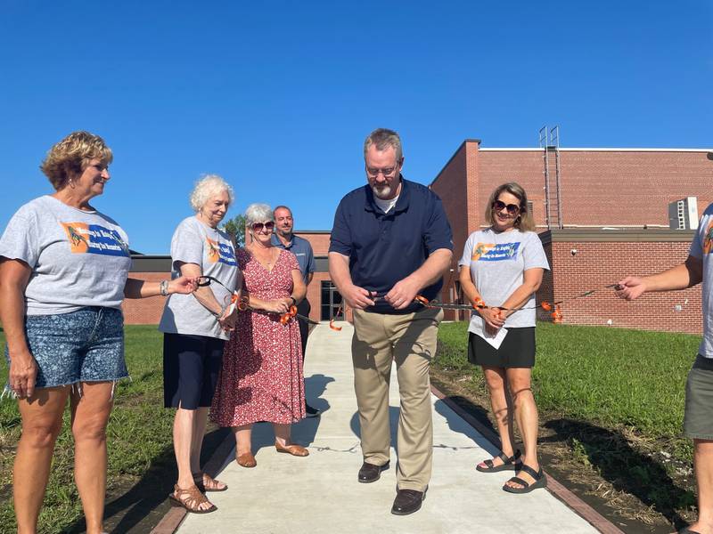 Fieldcrest superintendent Dave Johnson cuts the ceremonial ribbon Saturday, Aug. 12, 2023, outside Fieldcrest Middle School in Wenona. The campus has undergone major renovations including demolition of its oldest section.