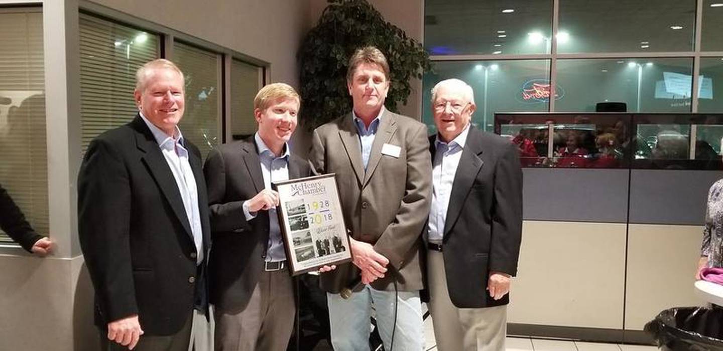 Buss Ford Lincoln in McHenry celebrated its 90th anniversary in 2019. Pictured are (from left) Steve Buss, Drew Buss, McHenry Area Chamber of Commerce Chairman Denny Norton and Ed Buss.