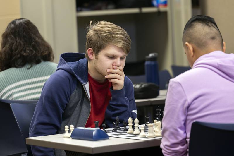 Sterling High School senior Dayton Fisher thinks about his game strategy while playing a practice round against chess teammate Jose Figuroa on Wednesday.