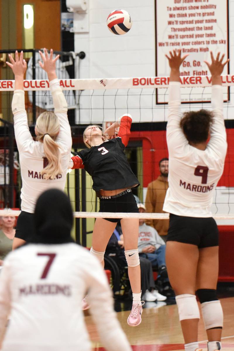 Bradley-Bourbonnais' Samantha Harsy, center, looks to place a hit between the Champaign Central defense during a game at Bradley-Bourbonnais Thursday, Oct. 23, 2025.