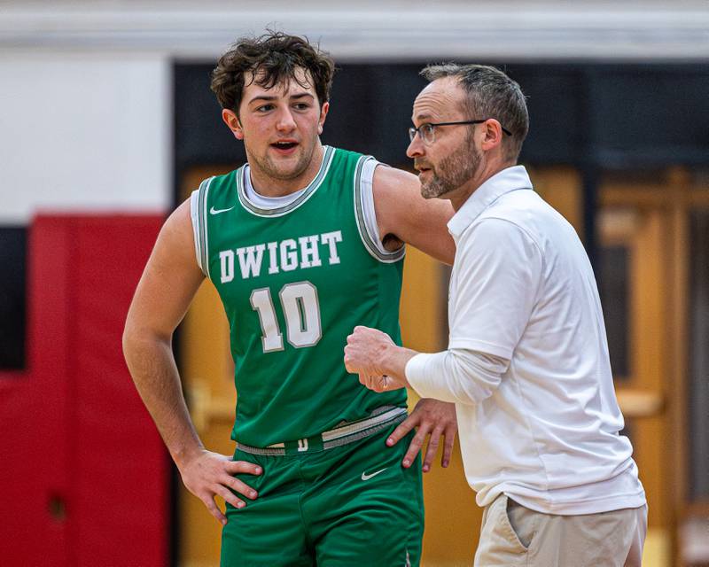 Dwight's Head Coach Jeremy Connor talks to player Evan Cox (10) as Marquette shoots free throws on Saturday, Feb. 21, 2026 at Marseilles Elementary School.