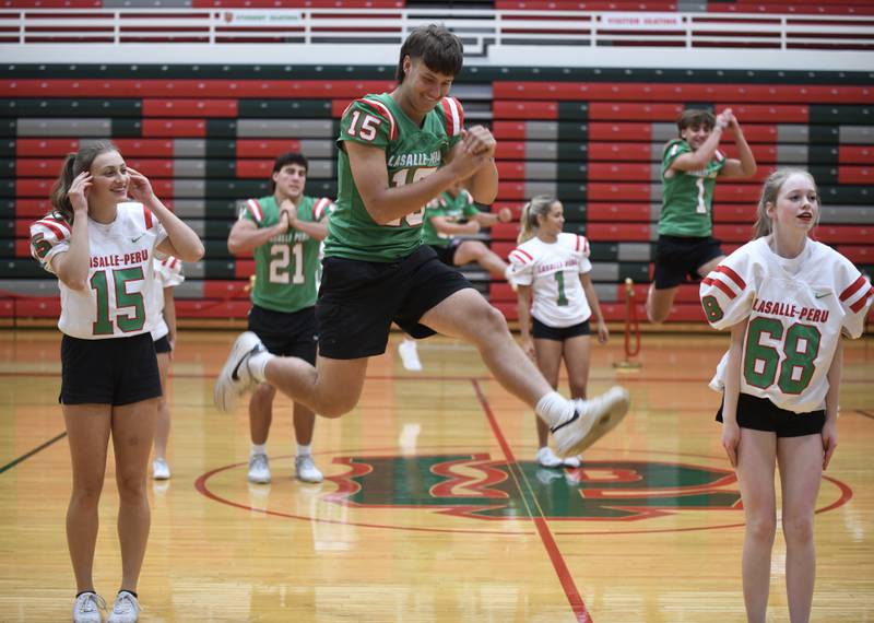 L-P quarterback Brendan Boudreau leaps in the air during a dance routine with the L-P Cheerleaders at the LPHS Variety Show on Monday, Oct. 2, 2023 in Sellett Gym.