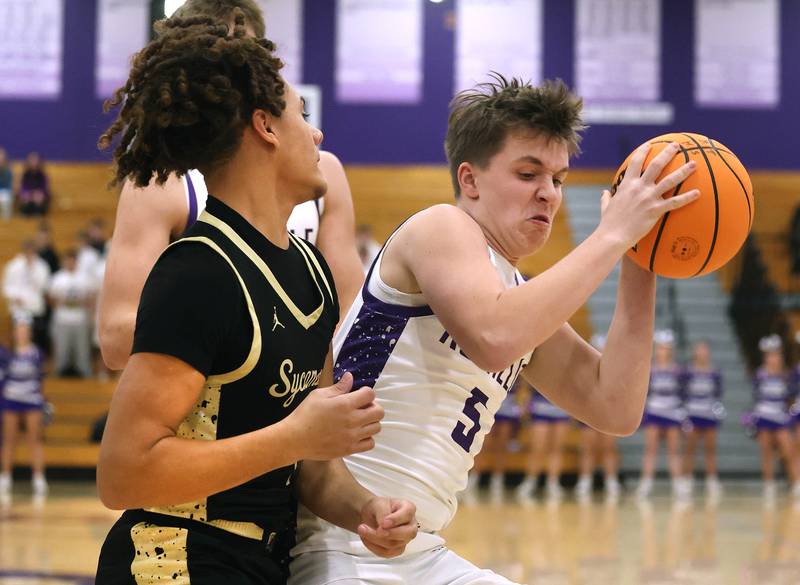 Rochelle's Mason Ludwig grabs a rebound in front of Sycamore's Josiah Mitchell Friday, Dec. 5, 2025, during their game at Rochelle High School.