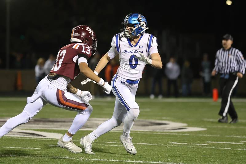 St. Charles North's Aidan McClure follows the receiver against Brother Rice in the third round of the playoffs on Saturday, Nov. 15, 2025 in Chicago.