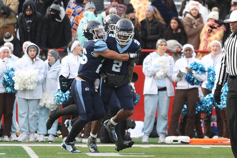 Nazareth’s Garrett Reese (2) is greeted by Dylan Wellner after stopping Joliet Catholic from tying the game on a 2-point conversion in the Class 5A state championship on Saturday, Nov. 30, 2024 in Normal.