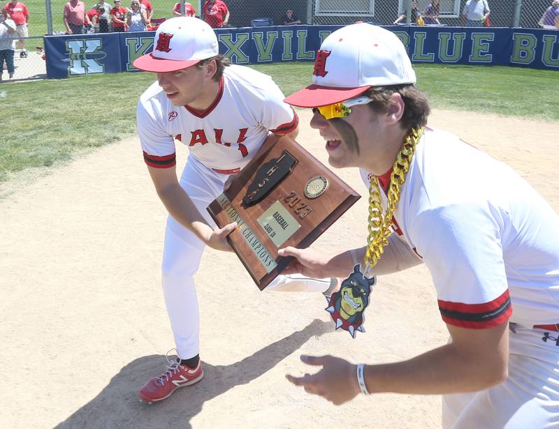 Hall's Riley Coble and Ashton Peacher carry the Class 2A Sectional plaque after defending Sherrard in the Class 2A Sectional final game on Saturday, May 27, 2023 at Knoxville High School.