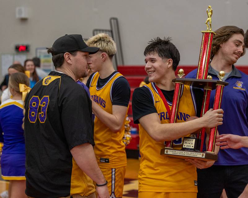 Oliver Munoz (13) of Mendota laughs with Athletic Director Chance Blumhorst after win in championship game of the Colmone Classic on Saturday, December 20, 2025 at Hall High School in Spring Valley.