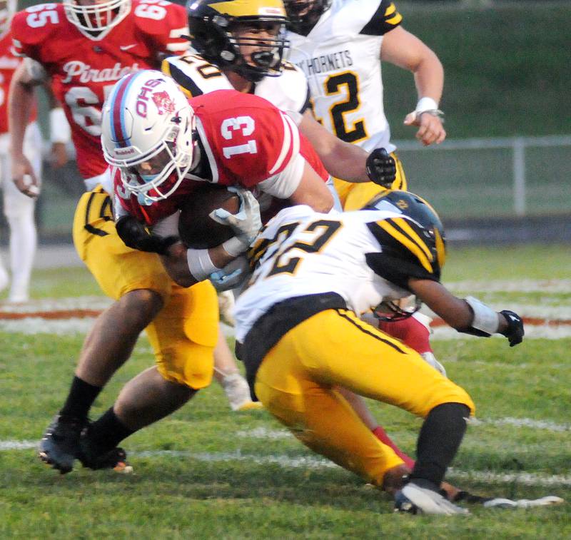 Ottawa's Ryder Miller (13) is sandwiched by Harvard's Angel Deleon (20) and Edward Rosales at King Field on Friday, Sept. 8, 2023.