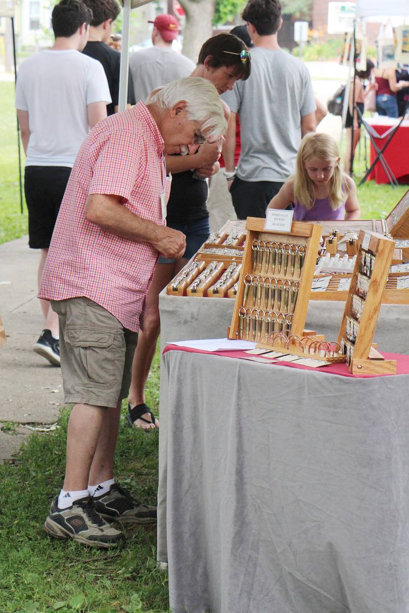 Vahan Bedeian restocks his jewelry Saturday, July 1, 2023 during Petunia Fest's Nuts About Art show at John Dixon Park in Dixon.