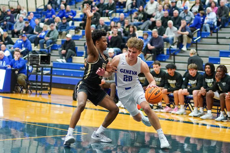 Geneva’s Jack Hatton (20) powers his way to the basket against Glenbard North's Maharri Thatch (21) during a class 4A Geneva Regional final basketball game at Geneva High School on Friday, Feb. 28, 2025.