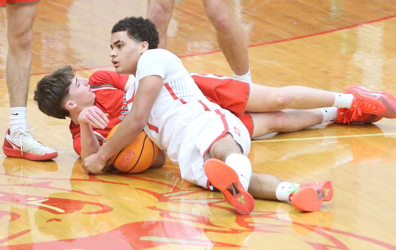 L-P's John Sowers and Streator's Layzeric Moton scramble for a loose ball on Tuesday, Jan. 13, 2026 in Pops Dale Gymnasium at Streator High School.