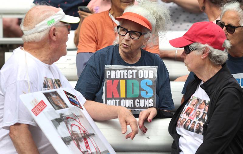Bill Mitchell, (left) Lea Gorman, and Betty Mitchell (right) chat Saturday, June 11, 2022, during a March For Our Lives event at Hopkins Park in DeKalb. The March For Our Lives initiative advocates for, among other things, an end to gun violence, updated gun control legislation and policy targeting gun lobbyists.