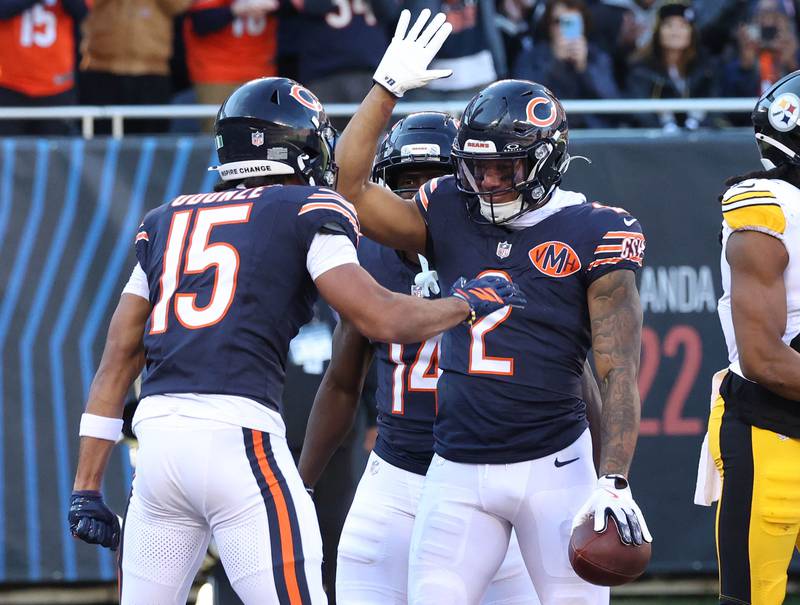 Chicago Bears wide receiver DJ Moore (right) celebrates his touchdown catch with teammate Rome Odunze Sunday, Nov. 23, 2025, during their game against the Pittsburgh Steelers at Soldier Field in Chicago.
