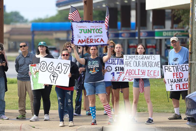A group stands at the intersection of North Larkin Avenue and West Jefferson Street for the No Kings' Day protest on Saturday,  June 14, 2025 in Joliet.