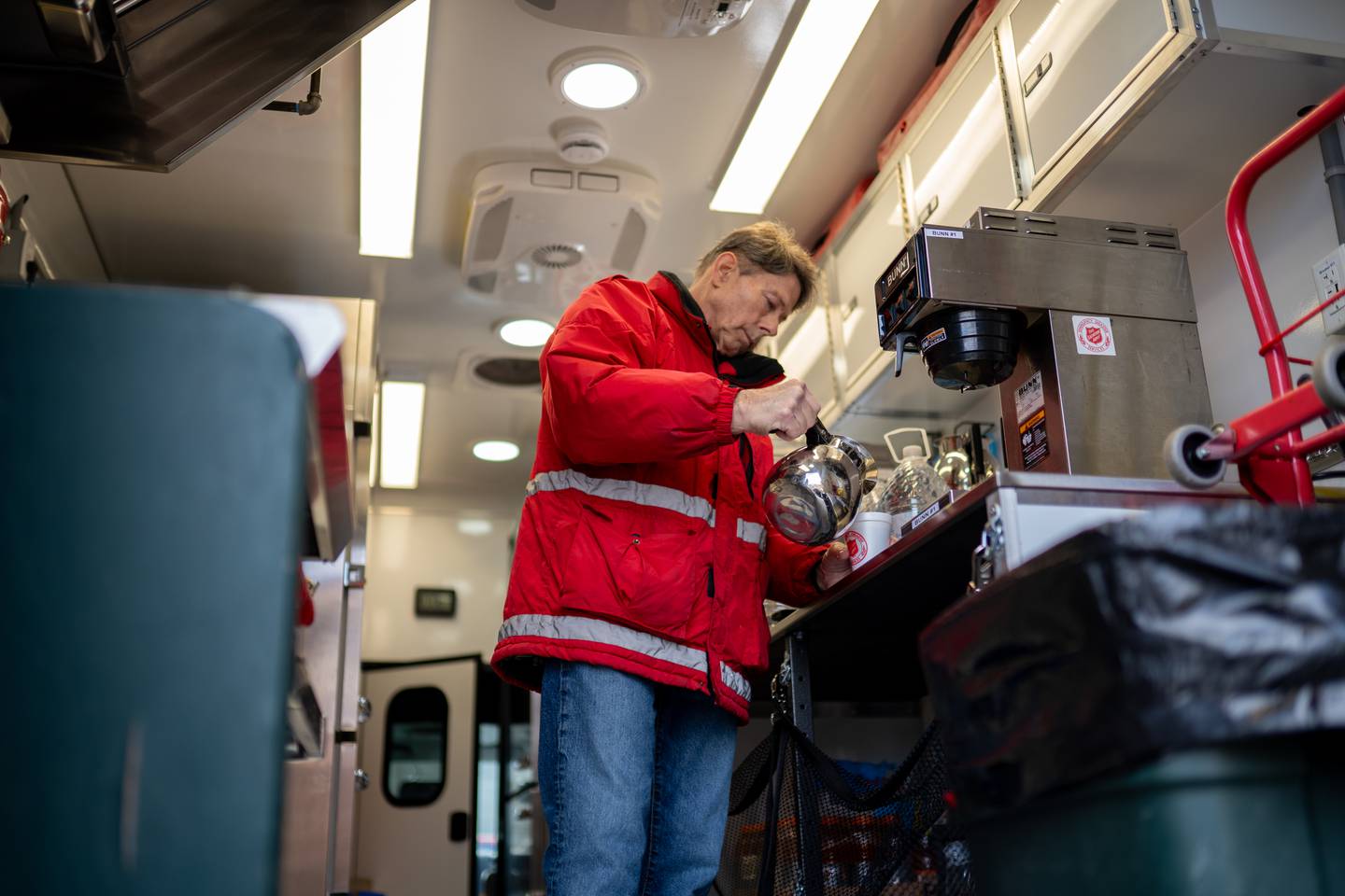 Salvation Army volunteer Tom Allen pours a cup of coffee in the new emergency canteen during the ribbon-cutting ceremony on April 6, 2026, in Crystal Lake.