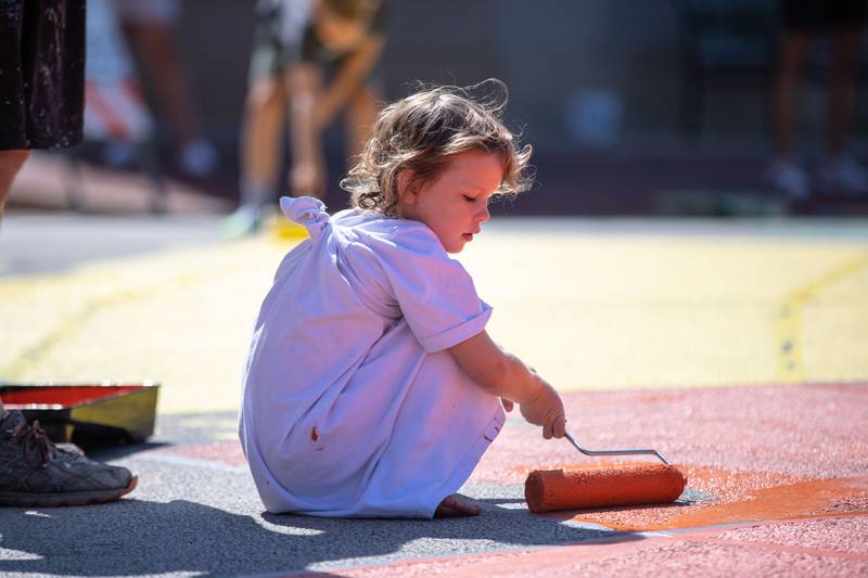 Isla Madigan, 5, of St. Charles paints the intersection of Riverside Avenue and Walnut Street in St. Charles at the Paint the Riverside event hosted by the St. Charles Arts Council on Saturday, July 30, 2022.