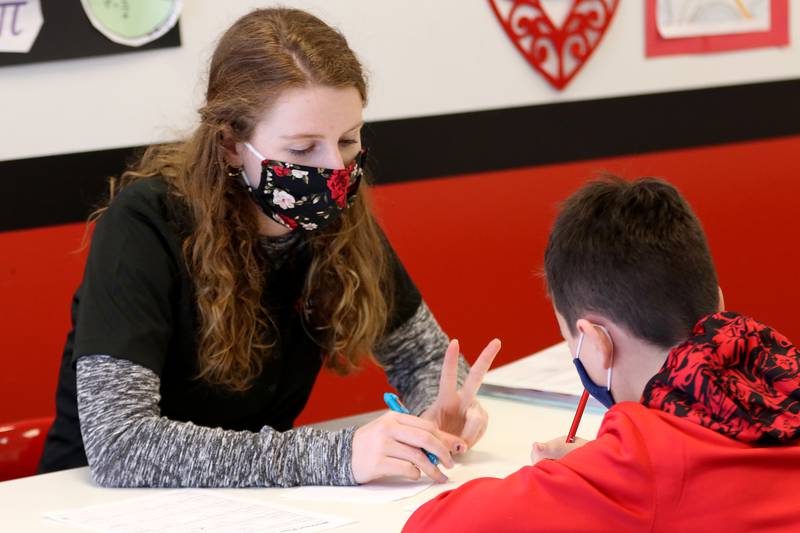 Mathnasium tutor Grace Clark, a senior at Jacobs High School, helps sixth grade student Calvin DeHaven with math problems at Mathnasium on Thursday, Feb. 11, 2021 in Algonquin.