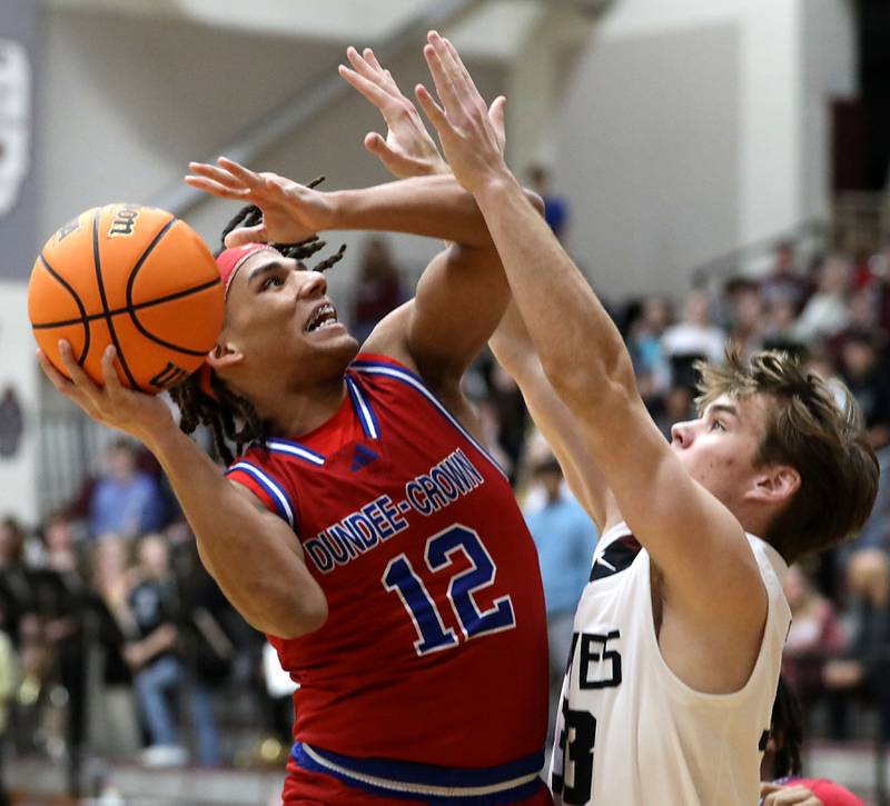 Dundee-Crown's Anthony Spain shoots the ball over Prairie Ridge's Maddon McKim during a Fox Valley Conference boys basketball game on Friday, Jan. 16, 2026, at Prairie Ridge High School in Crystal Lake.