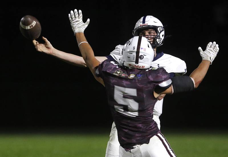 Cary-Grove's Peyton Seaburg throws a pass around Prairie Ridge's Andrew Koeppen during a Fox Valley Conference football game on Friday, Sept. 27, 2024, at Prairie Ridge High School.