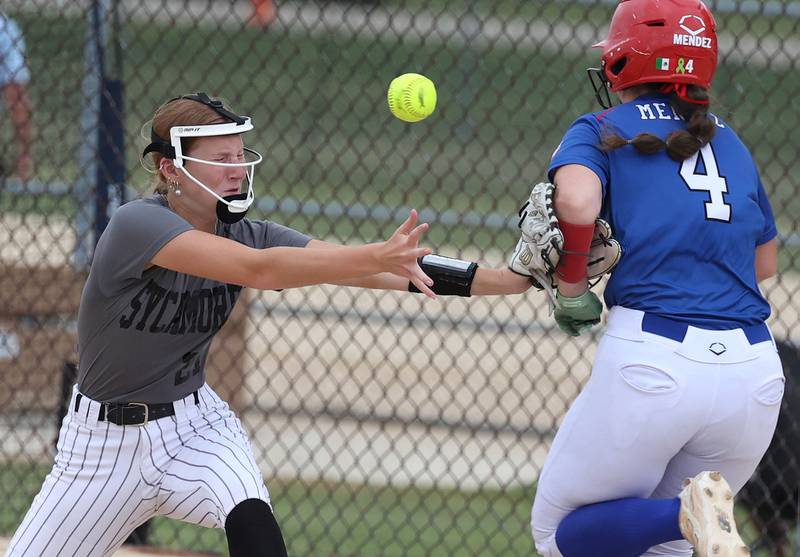 Sycos’ Layna Peterson nearly has a collision on a throw to first Friday, June 27, 2025, during their 16u game against Select Fastpitch in the Storm Days tournament at the Sycamore Community Sports Complex.