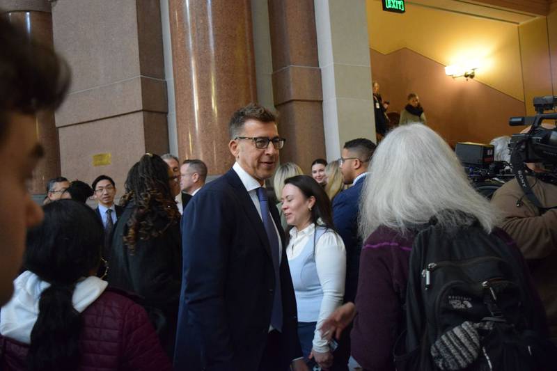 Illinois Secretary of State Alexi Giannoulias exits the House chambers in the Illinois Capitol.