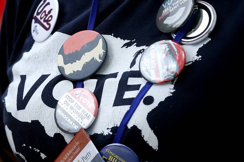 Campaign button cover a vote t-shirt on Sunday, July 7, 2024, during Crystal Lake’s annual Independence Day Parade on Dole Avenue in Crystal Lake. This year’s parade feature close to 100 units.
