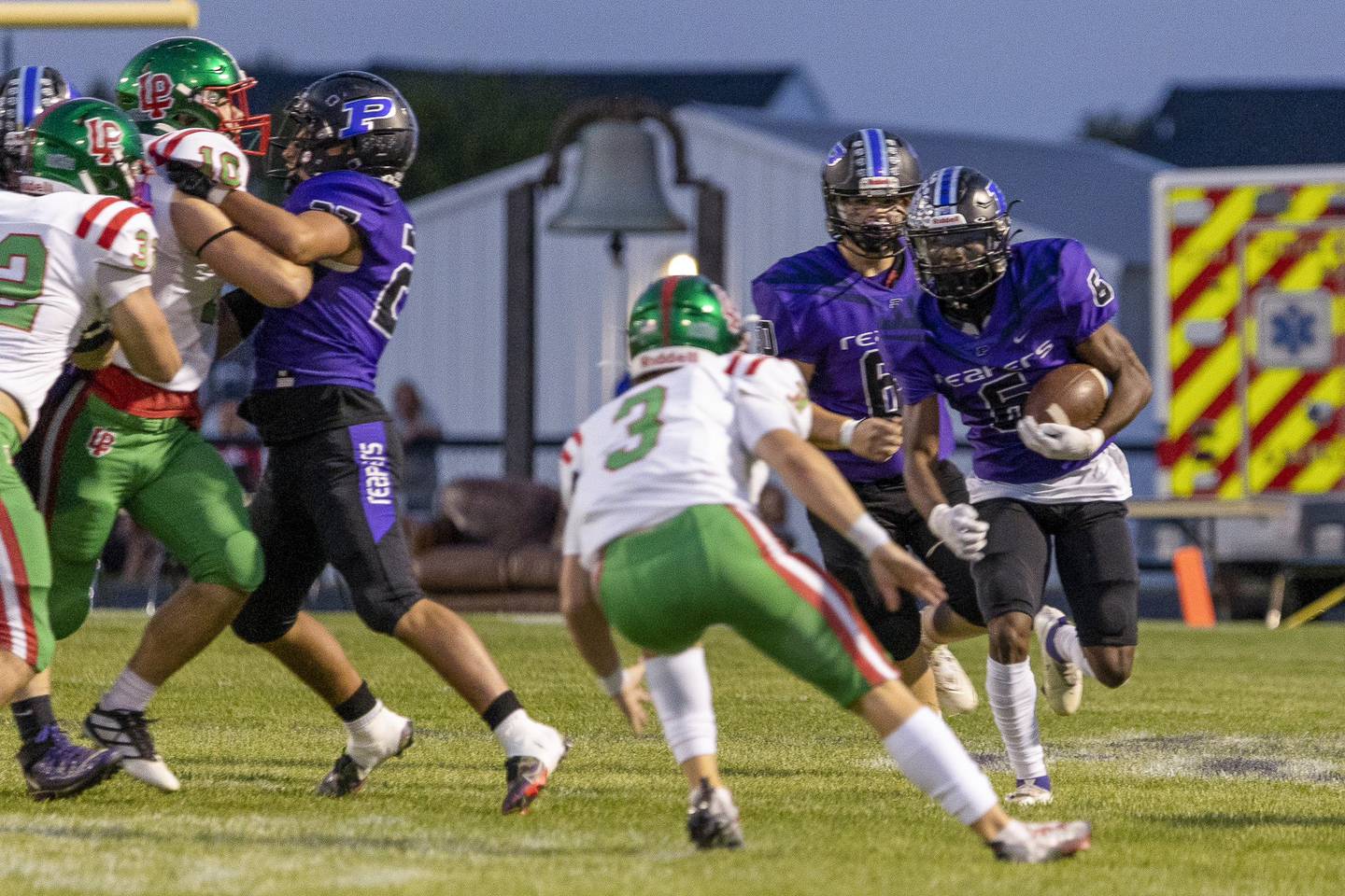 Plano's Waleed Johnson (6) looks for an opening as La Salle-Peru's Mason Lynch (3) closes in during Friday's game in Plano.