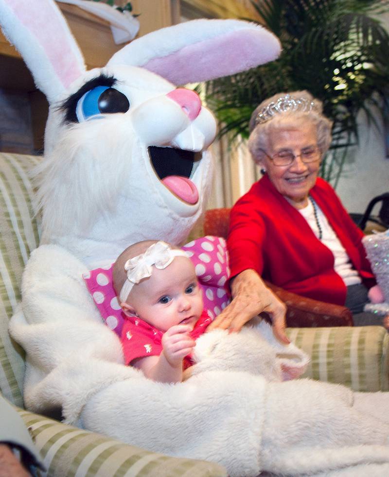 Charlotte Rauhut, four months old, is held by the Easter Bunny as Timbers resident, Fran Podobnik, enjoys the moment during the Hippity-Hop Easter Egg Hunt on April 4 at The Timbers of Shorewood retirement community in Shorewood.
