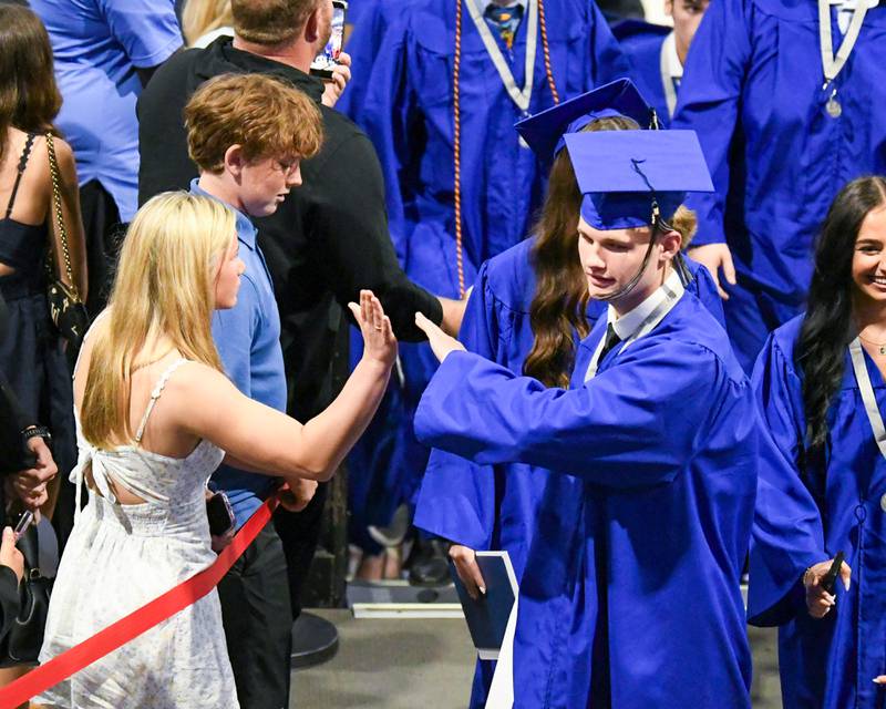 A St. Charles North graduate gets a high-five during the graduation ceremony on Monday May 18, 2026, held at the NIU Convocation Center in DeKalb.
