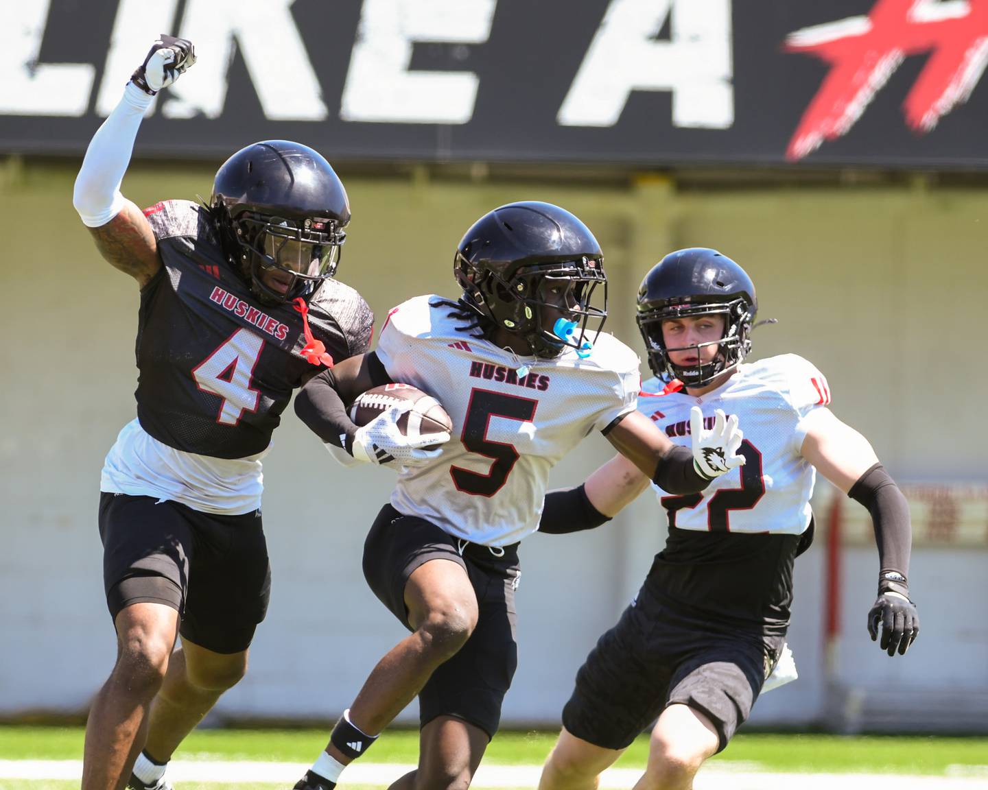 Northern Illinois University's cornerback Yassine Falke (5) runs the ball after intercepting the ball while Northern Illinois University's wide receiver Kenji Lewis (4) defends him during the spring football scrimmage on Saturday, April 25, 2026, held at Huskie Stadium in DeKalb.