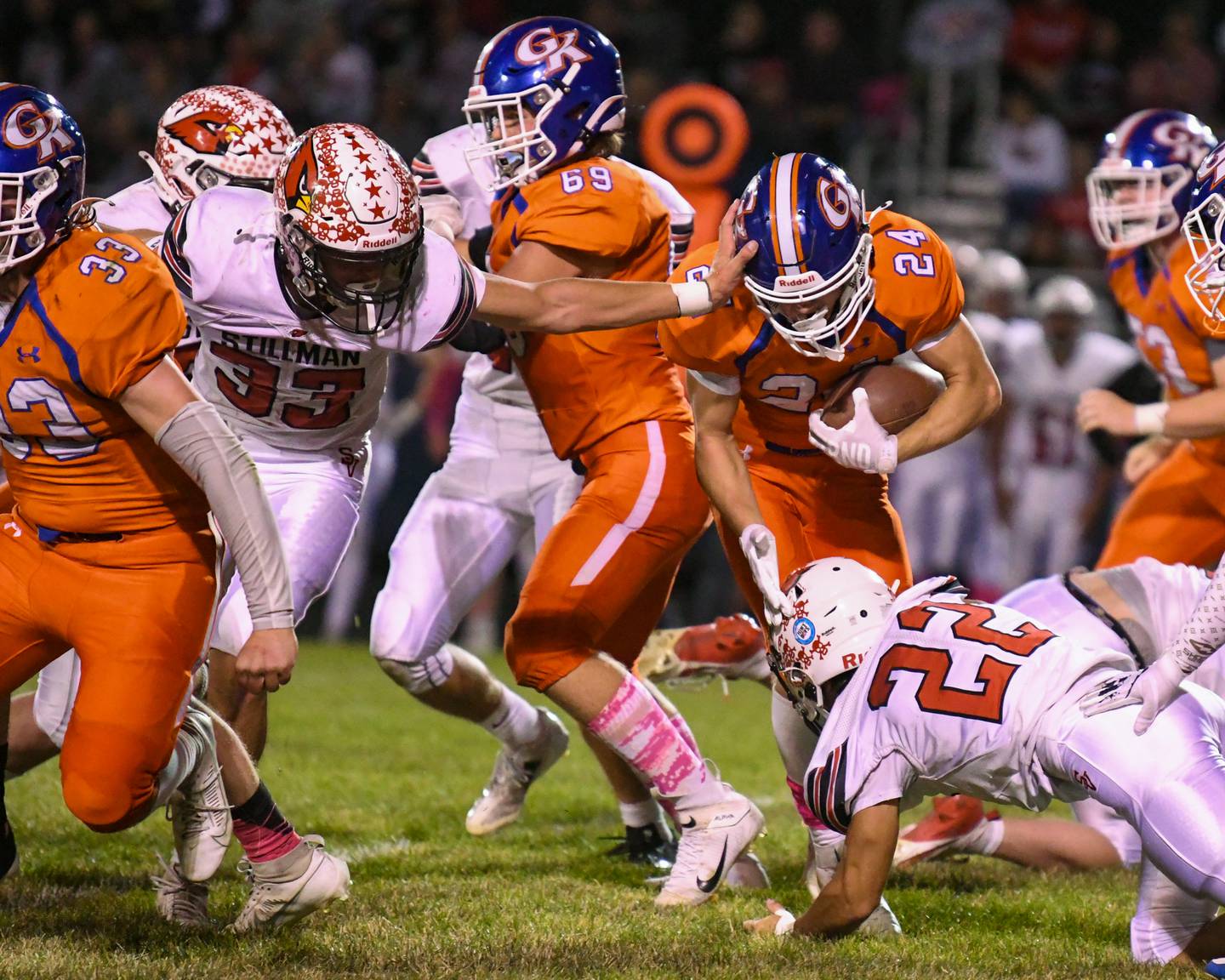 Genoa-Kingston's Patrick Young (24) maneuvers around Stillman Valley defenders to gain some extra yards before being taken down on Friday Oct. 11, 2024, held at Genoa-Kingston High School.