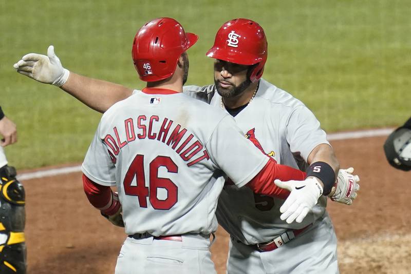 St. Louis Cardinals' Albert Pujols, right, celebrates with Paul Goldschmidt (46) after he hit home run number 703 in his career during the fifth inning of a baseball game. (AP Photo/Keith Srakocic)