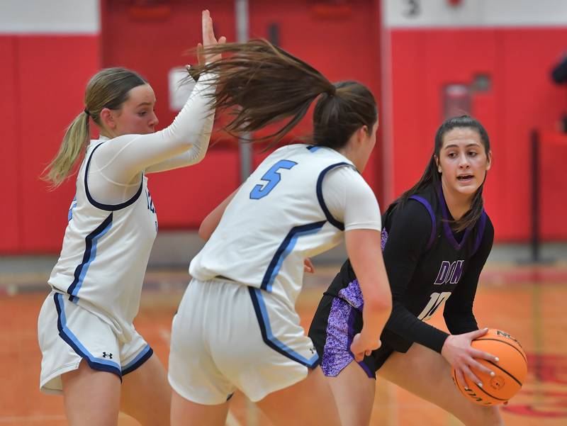 Nazareth’s Lyla Shelton and Sophia Towne double team Downers Grove North’s Campbell Thulin during the Class 4A Hinsdale Central Sectional final game on February 26, 2026 at Hinsdale Central High School in Hinsdale.