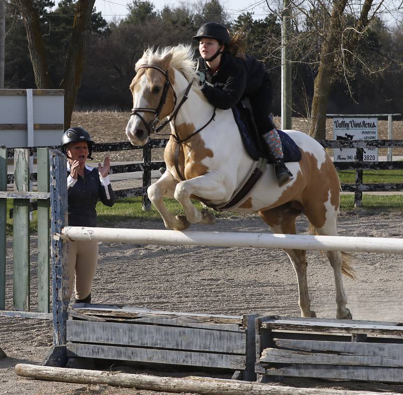 Teacher Amber Bauman works with Violet Capra and Capra's horse, Angel, on Wednesday, April 16, 2025, during a horseback riding lesson at Valley View Acres near Woodstock. Bauman, also teaches 6th grade math at Hannah Beardsley Middle School in Crystal Lake.